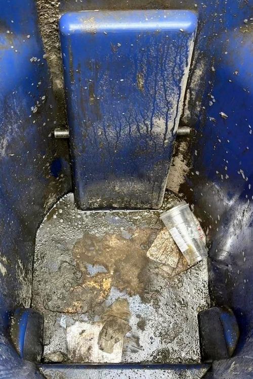 Before trash bin cleaning: dirty blue trash bin with grime and debris